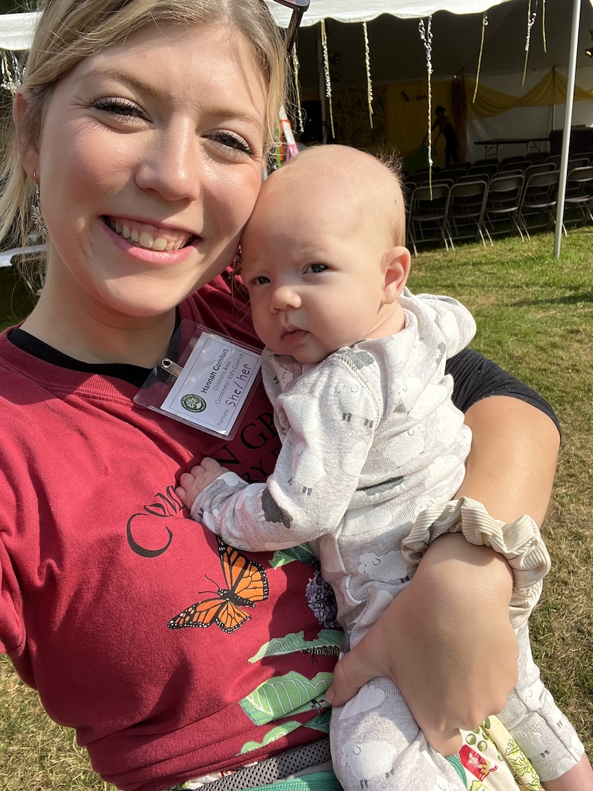 MOFGA volunteer Hannah Comfort holds her niece at the Common Ground Country Fair